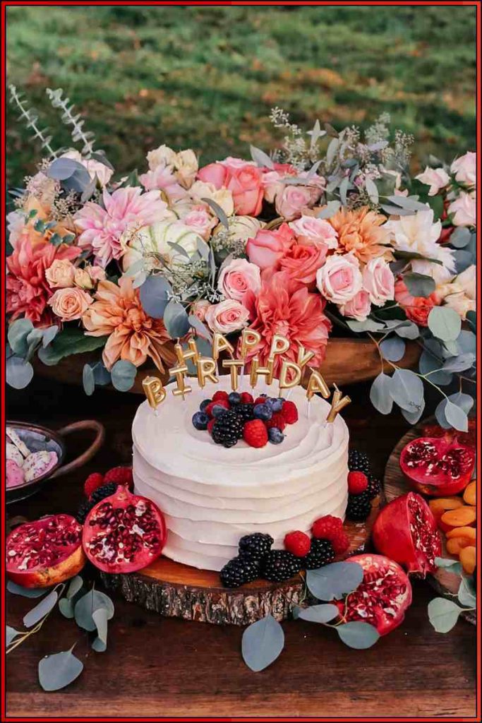 birthday cake between flowers